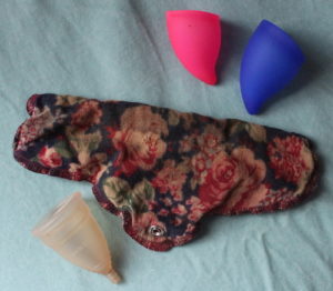 3 menstrual cups and a cotton pad